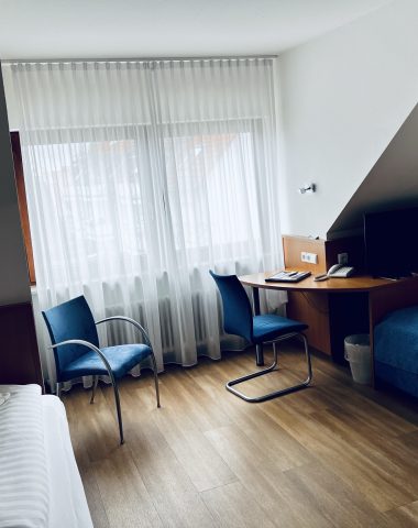 Modern hotel room interior with natural lighting.