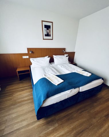 Modern bedroom with double bed and blue bedding.