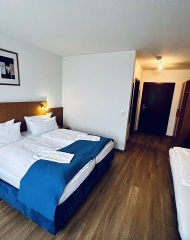 Comfortable hotel room with double and single beds.