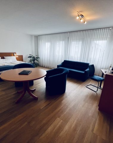 Modern hotel room interior with furniture.